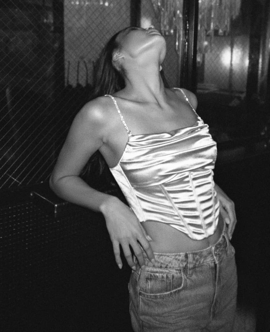 A model wears a satin corset tank